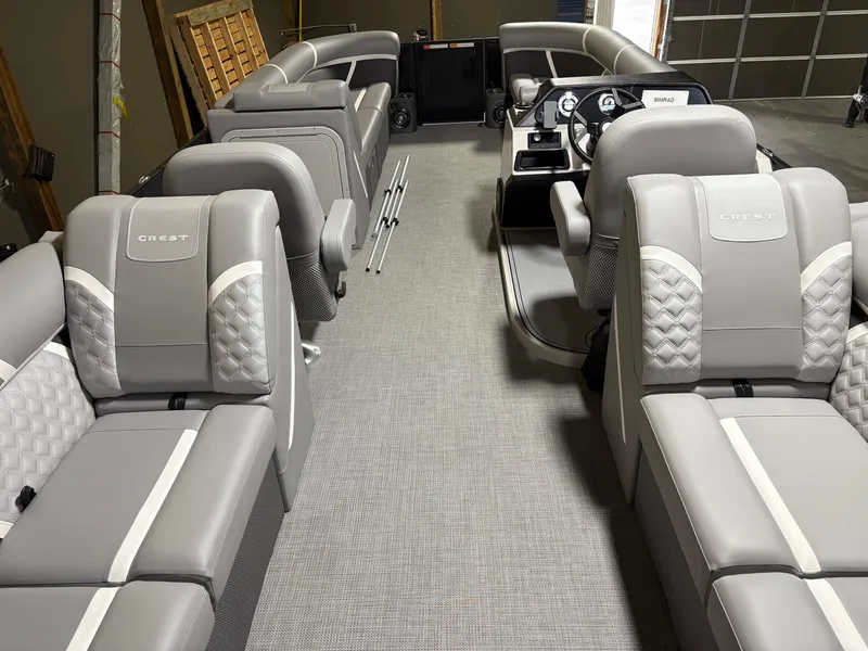 Slide: The Image of 2025 Crest 240 SLC boat interior with luxurious gray seating and modern dashboard. - 4