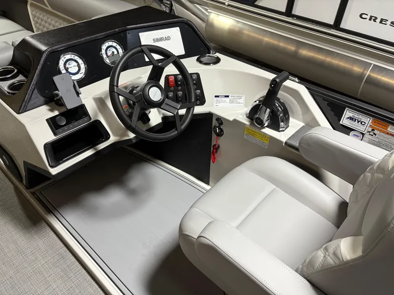 Slide: The Image of 2025 Crest 240 SLC boat dashboard with steering wheel and controls. - 6