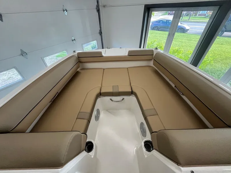 Slide: The Image of Interior seating of 2025 Bayliner D20 boat, featuring tan cushions and modern design. - 10