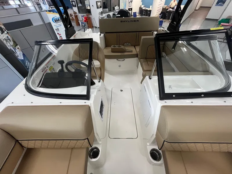 Slide: The Image of Interior view of 2025 Bayliner D20 boat with tan seating and modern dashboard. - 11