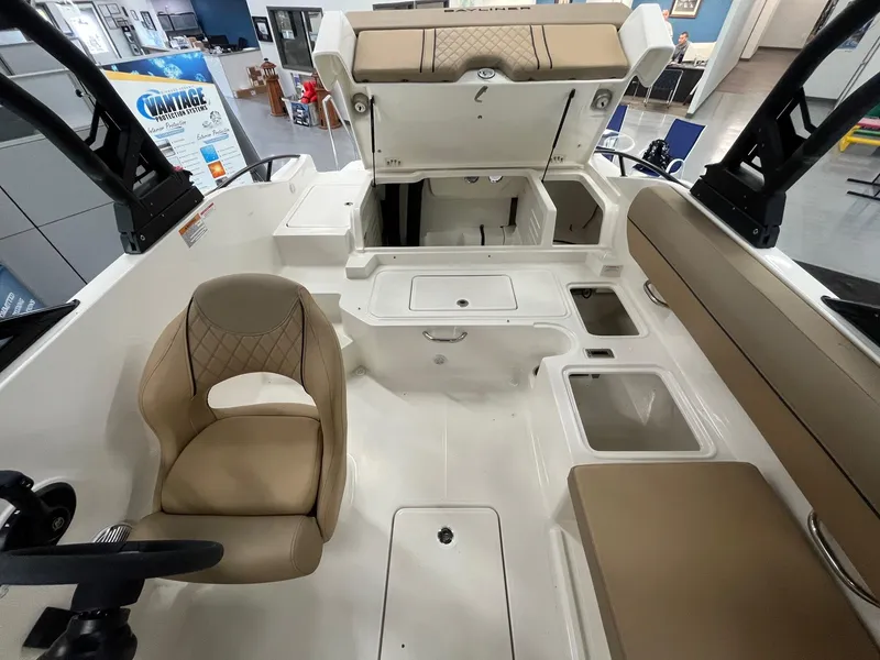 Slide: The Image of Interior view of 2025 Bayliner D20 boat, featuring seating and storage compartments. - 13