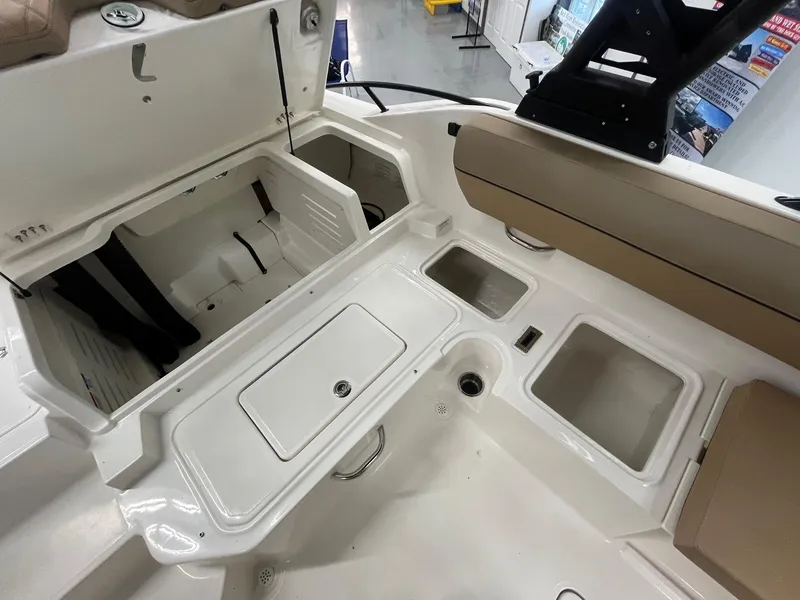 Slide: The Image of 2025 Bayliner D20 boat interior with storage compartments and seating. - 14