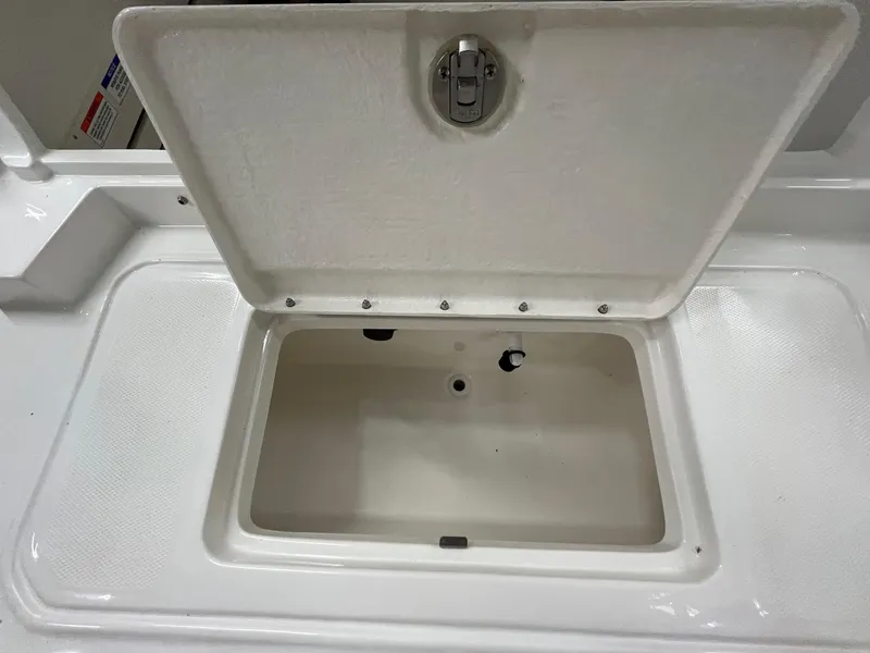 Slide: The Image of Open storage compartment on 2025 Bayliner D20 boat. - 15