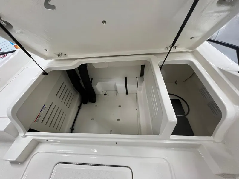 Slide: The Image of Open storage compartment of 2025 Bayliner D20 boat, showcasing spacious interior design. - 16