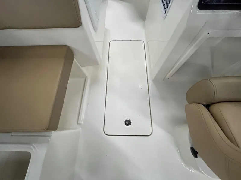 Slide: The Image of 2025 Bayliner D20 interior with beige seating and white flooring. - 17