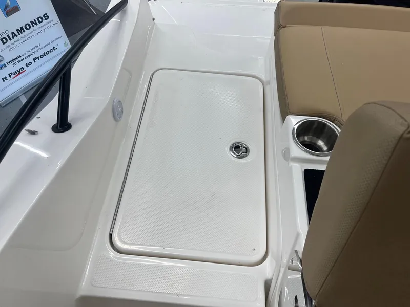 Slide: The Image of Interior view of 2025 Bayliner D20 boat with seating and storage compartment. - 19