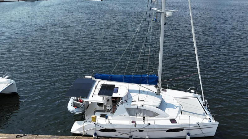Slide: The Image of 2012 Leopard 39 Owner's Version catamaran docked on calm water. - 10