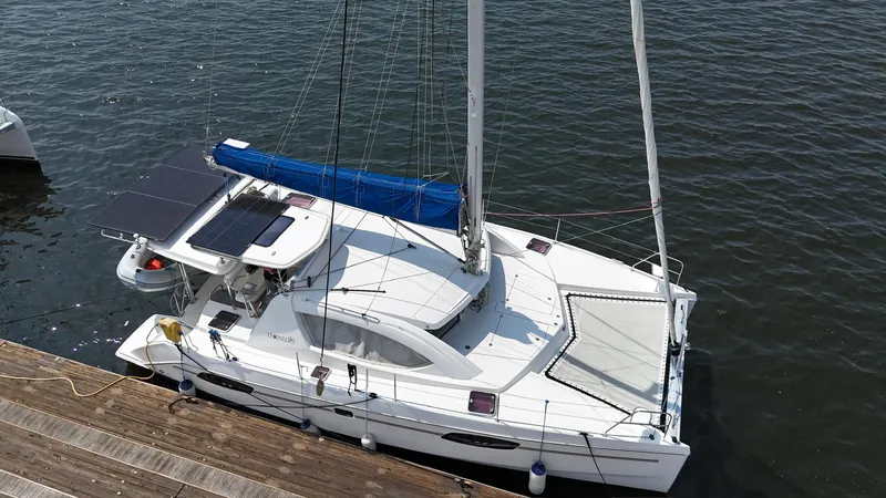 Slide: The Image of 2012 Leopard 39 Owner's Version catamaran docked, featuring solar panels and a sleek design. - 11