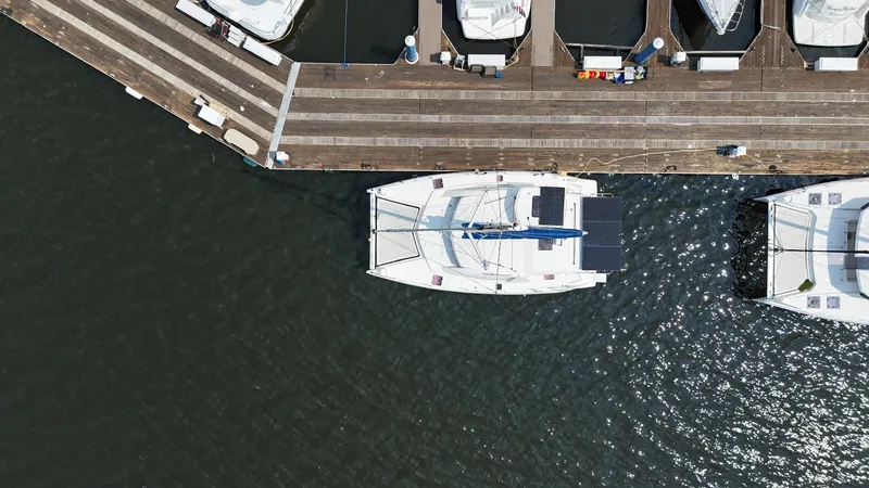 Slide: The Image of Aerial view of a 2012 Leopard 39 Owner's Version catamaran docked at a marina. - 12