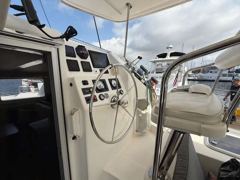 Slide: The Image of Helm of 2012 Leopard 39 Owner's Version catamaran with steering wheel and navigation instruments. - 14