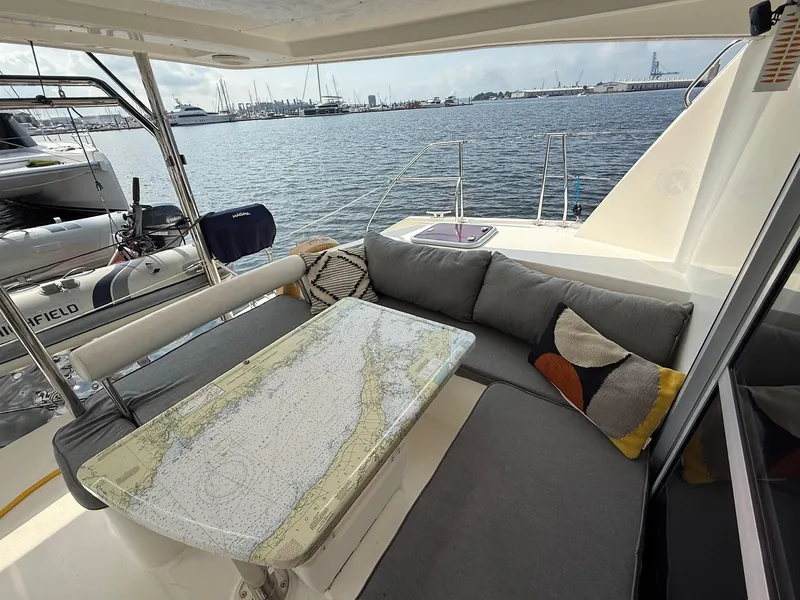 Slide: The Image of Cozy seating area on 2012 Leopard 39 Owner's Version yacht with nautical chart table. - 15