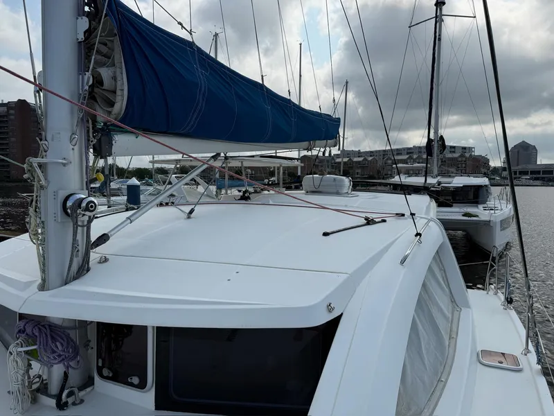 Slide: The Image of 2012 Leopard 39 Owner's Version catamaran docked at marina, featuring blue sail cover. - 24