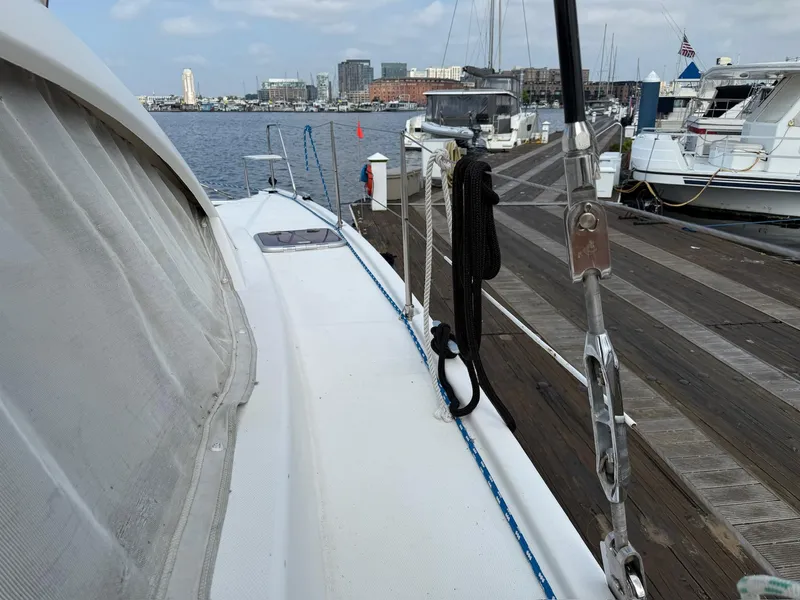 Slide: The Image of 2012 Leopard 39 Owner's Version yacht docked at marina, cityscape in background. - 27