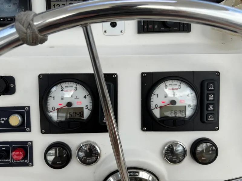 Slide: The Image of Control panel of a 2012 Leopard 39 Owner's Version yacht with gauges and switches. - 31
