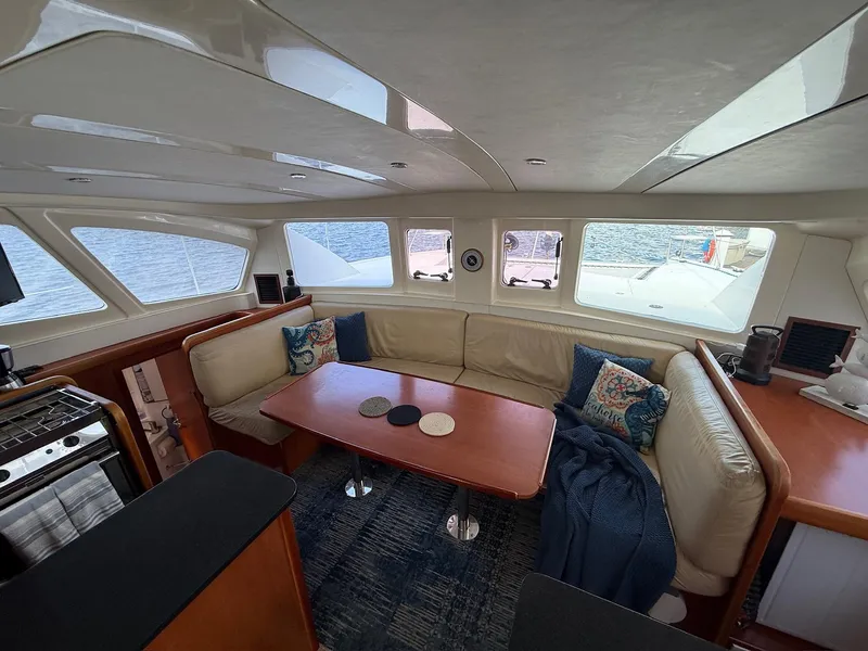 Slide: The Image of Interior of 2012 Leopard 39 Owner's Version catamaran with cozy seating and ocean view. - 32