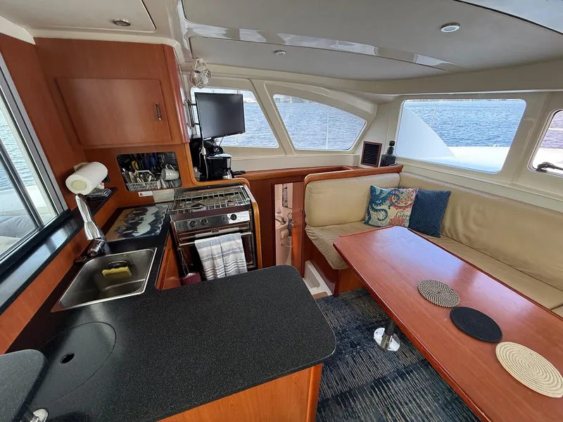 Slide: The Image of Interior of 2012 Leopard 39 Owner's Version yacht with kitchen and seating area. - 35
