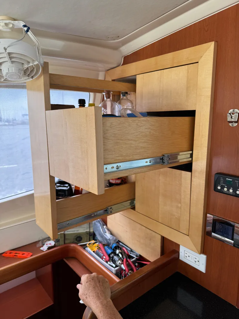 Slide: The Image of Interior of 2012 Leopard 39 yacht with open wooden cabinets and visible storage. - 38
