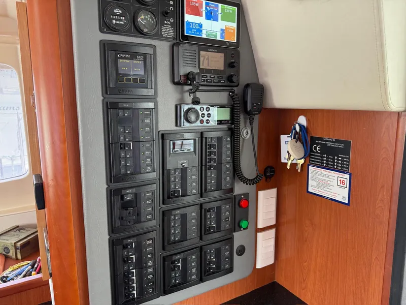 Slide: The Image of Control panel of a 2012 Leopard 39 Owner's Version yacht with navigation and communication equipment. - 39