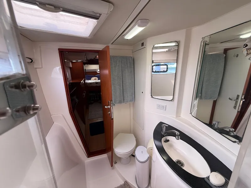Slide: The Image of Leopard 39 Owner's Version 2012 yacht bathroom with sink, mirror, and toilet. - 43