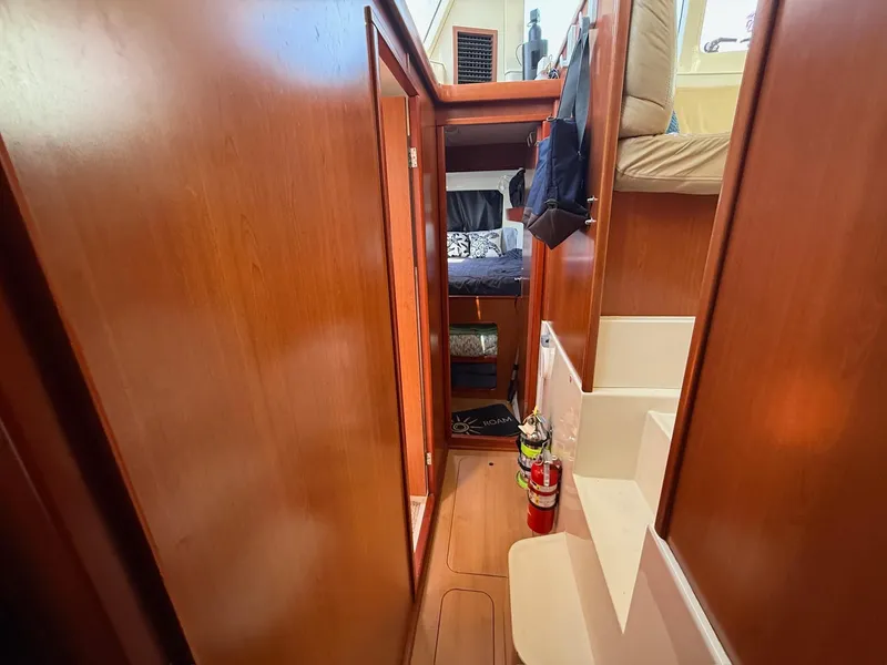 Slide: The Image of Interior of 2012 Leopard 39 Owner's Version yacht, featuring wooden cabinetry and cozy sleeping area. - 49