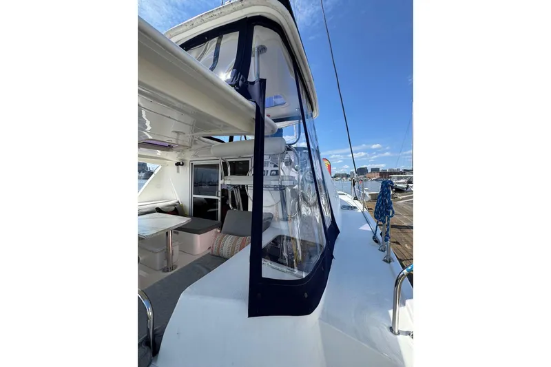 Slide: The Image of 2012 Leopard 39 Owner's Version catamaran, featuring spacious deck and seating area, docked at marina. - 57