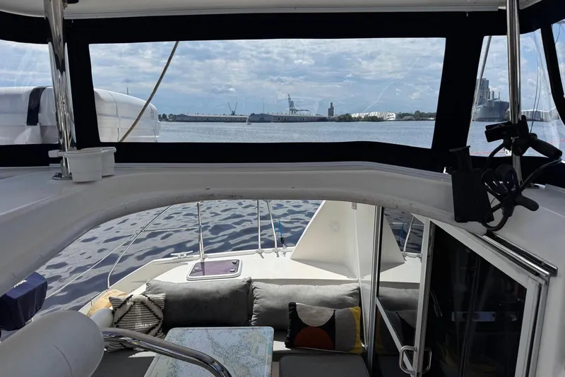 Slide: The Image of Interior view of 2012 Leopard 39 Owner's Version catamaran with waterfront backdrop. - 60