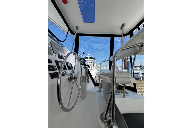 Slide: The Image of Interior view of 2012 Leopard 39 Owner's Version yacht helm with steering wheel and seating. - 63