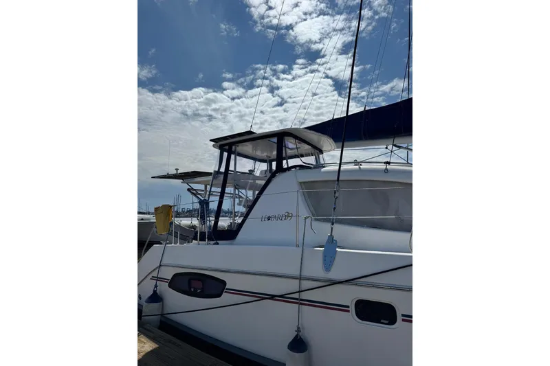 Slide: The Image of 2012 Leopard 39 Owner's Version catamaran docked under a partly cloudy sky. - 65
