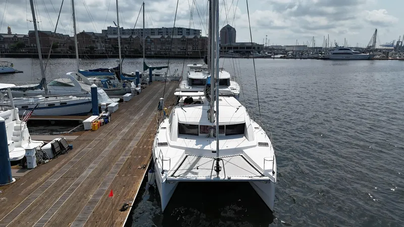 Slide: The Image of 2012 Leopard 39 Owner's Version catamaran docked at a marina with other boats. - 9
