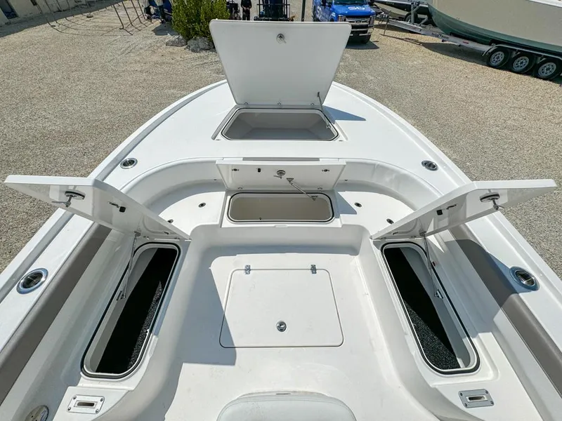 Slide: The Image of 2024 Caymas 28 HB boat deck with open storage compartments, showcasing spacious design. - 18