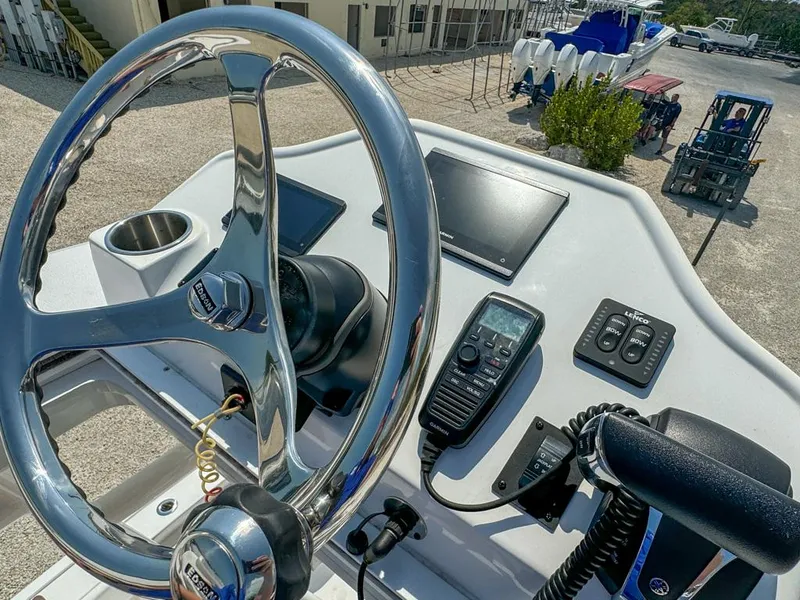 Slide: The Image of 2024 Caymas 28 HB boat helm with steering wheel, controls, and electronics. - 23