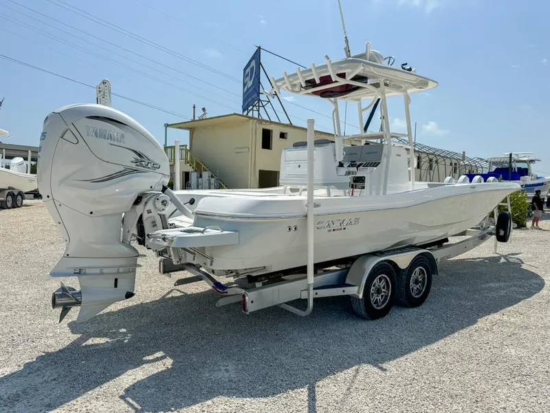 Slide: The Image of 2024 Caymas 28 HB boat on trailer with Yamaha outboard motor, parked outdoors. - 7