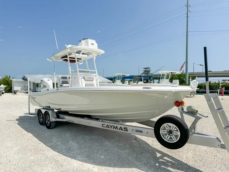 Slide: The Image of 2024 Caymas 28 HB boat on trailer, parked outdoors under clear sky. - 9