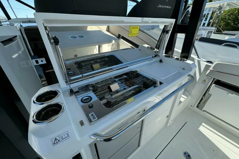 Slide: The Image of 2025 Jeanneau Leader 9.0 WA Series 2 boat interior with open grill and cup holders. - 4