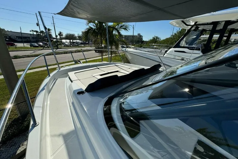 Slide: The Image of 2025 Jeanneau Leader 9.0 WA Series 2 boat, docked under a canopy, with sleek design. - 7