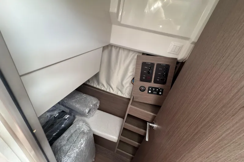 Slide: The Image of Interior of 2026 Jeanneau NC 895 Series 2 boat, featuring control panels and storage area. - 10