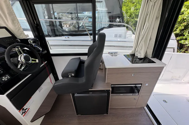 Slide: The Image of Interior of 2026 Jeanneau NC 895 Series 2 boat with helm, seating, and kitchenette. - 5