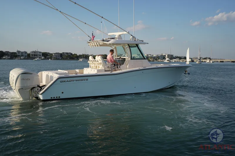 Slide: The Image of 2024 Grady-White Canyon 336 boat cruising on calm waters, side view. - 1