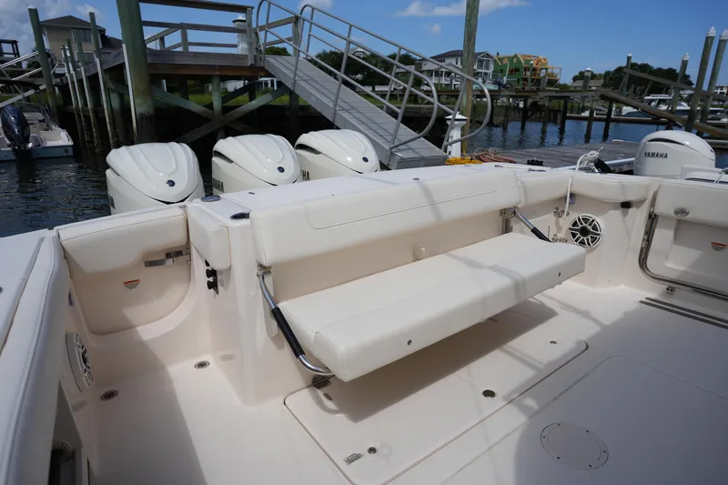 Slide: The Image of 2024 Grady-White Canyon 336 boat with Yamaha engines, docked, featuring a spacious seating area. - 14