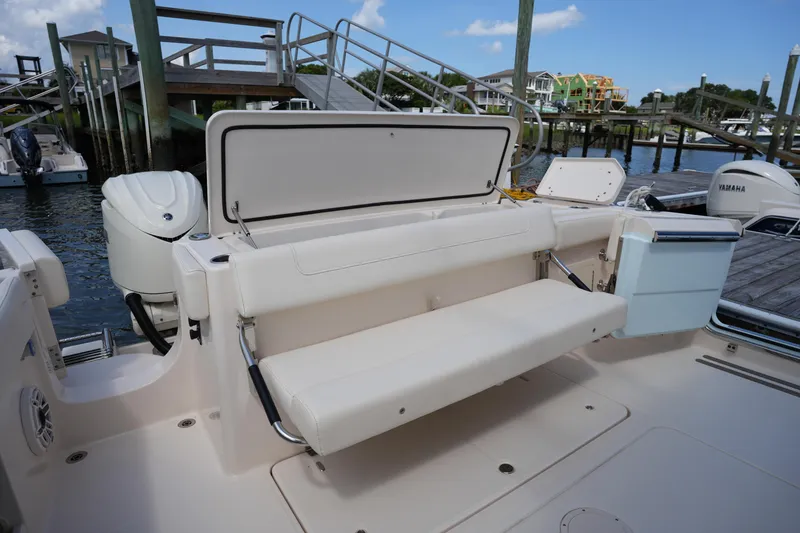 Slide: The Image of 2024 Grady-White Canyon 336 boat with foldable seating at a marina. - 15