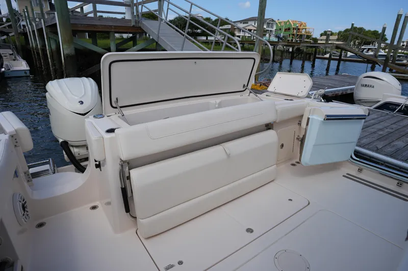 Slide: The Image of 2024 Grady-White Canyon 336 boat with open storage compartment at dockside. - 16