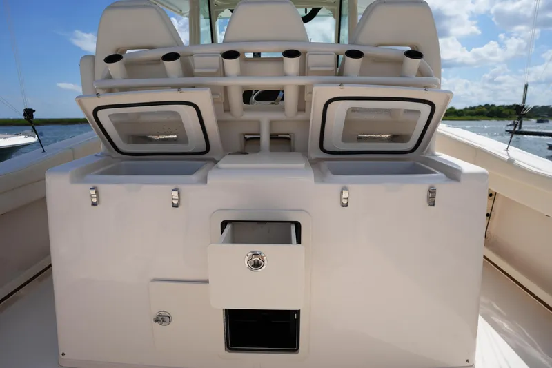 Slide: The Image of 2024 Grady-White Canyon 336 boat interior with storage compartments and rod holders. - 18