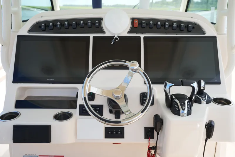 Slide: The Image of 2024 Grady-White Canyon 336 helm with dual screens and modern controls. - 23