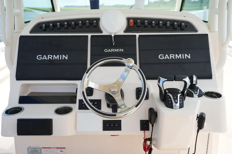 Slide: The Image of 2024 Grady-White Canyon 336 helm with Garmin displays and controls. - 24