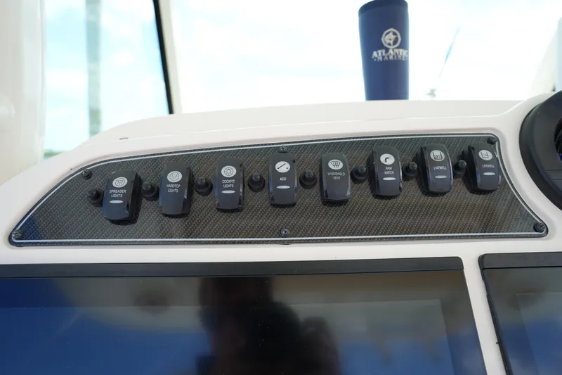 Slide: The Image of Control panel of 2024 Grady-White Canyon 336 boat with labeled switches. - 26