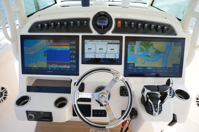 Slide: The Image of 2024 Grady-White Canyon 336 helm with advanced navigation displays and controls. - 28