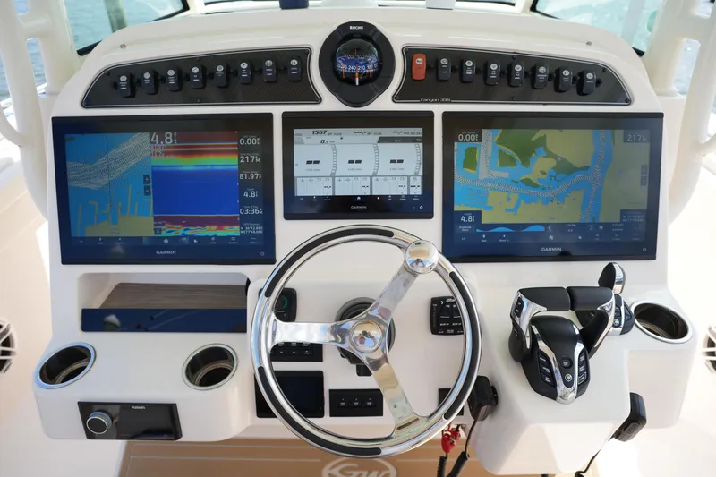 Slide: The Image of 2024 Grady-White Canyon 336 helm with advanced navigation displays and controls. - 29