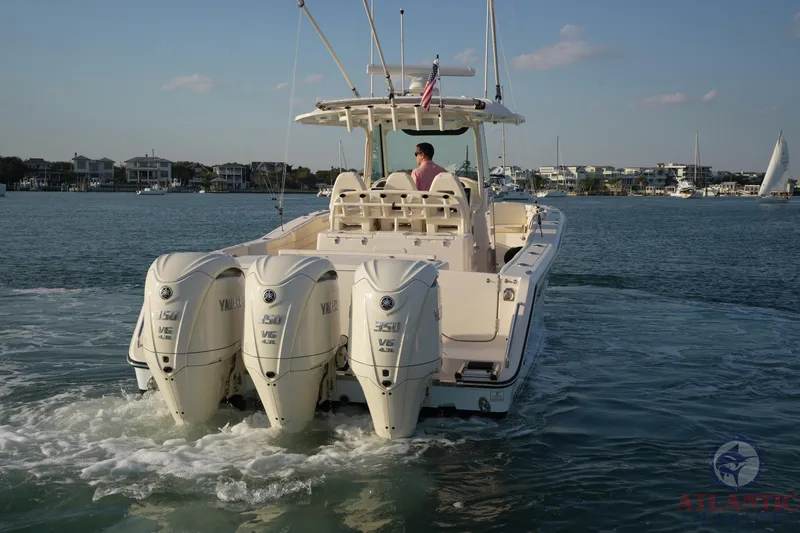 Slide: The Image of 2024 Grady-White Canyon 336 boat with triple Yamaha engines on the water. - 3