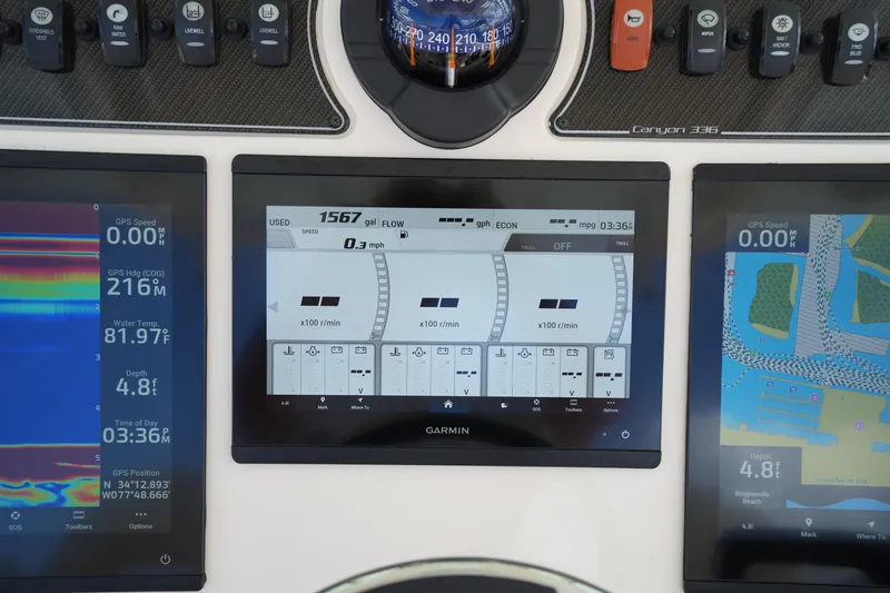 Slide: The Image of Dashboard of 2024 Grady-White Canyon 336 with Garmin navigation displays. - 31