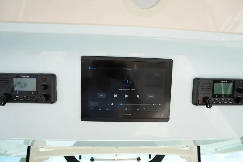 Slide: The Image of 2024 Grady-White Canyon 336 dashboard with Garmin electronics and Bluetooth connectivity. - 33